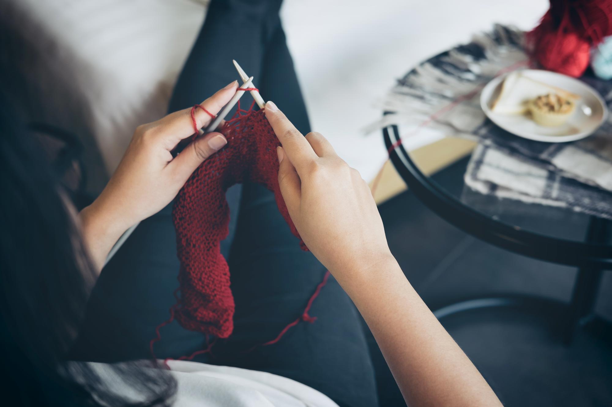 Artist at work embroidering a fabric in studio