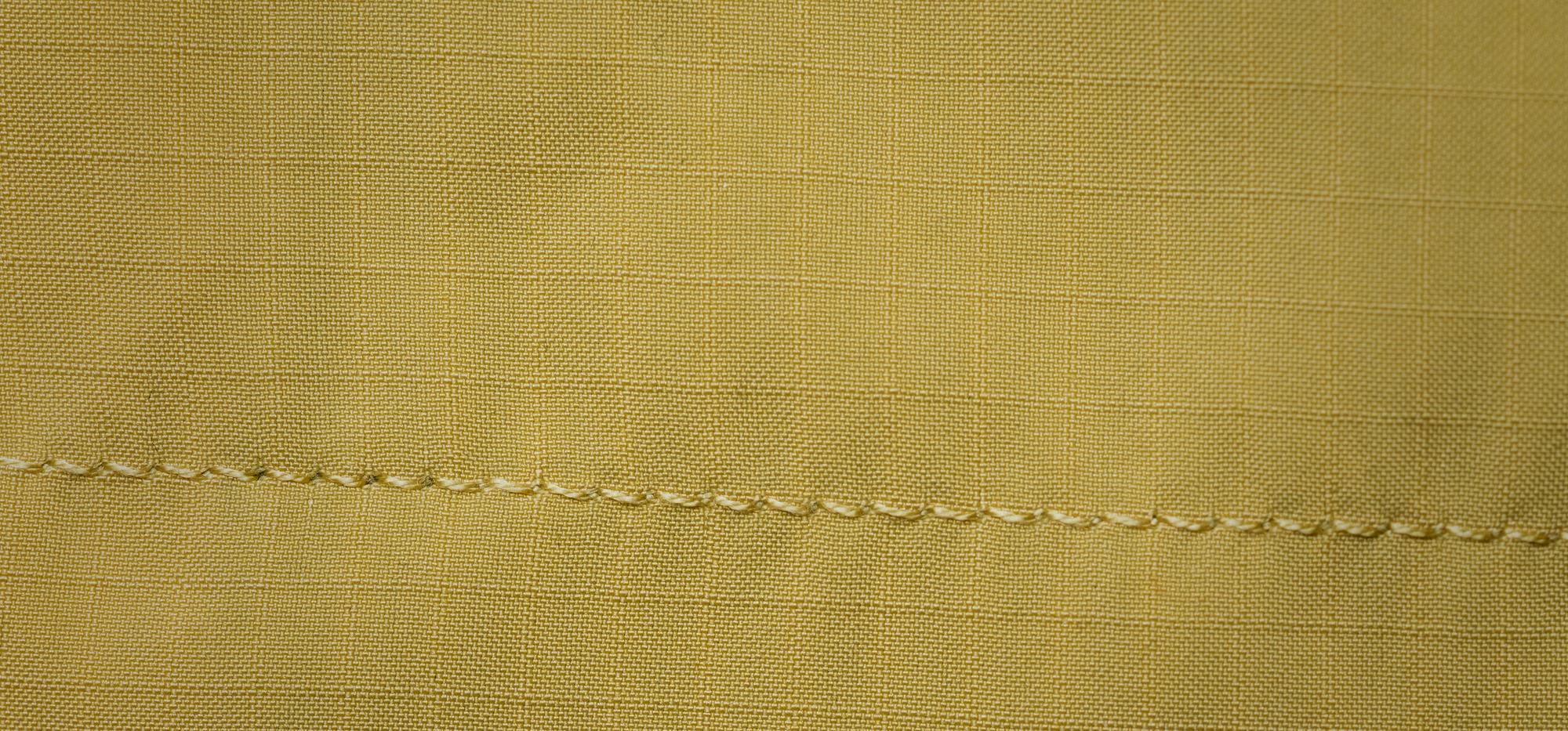 Large detail: layered satin stitches on linen
