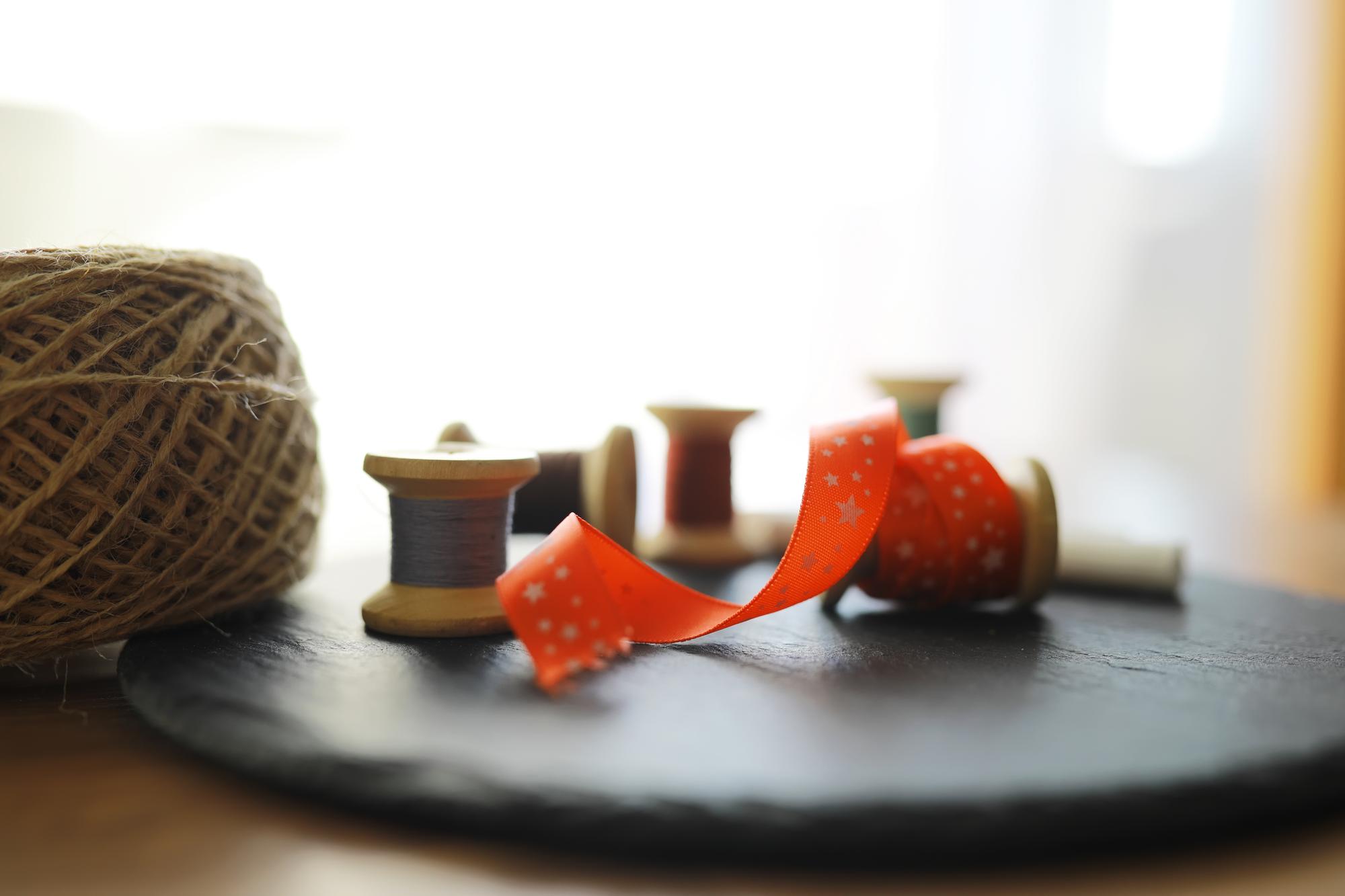 Smaller frame: studio workbench with threads